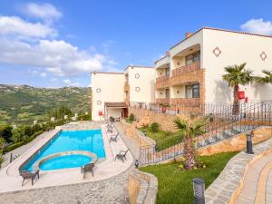 a resort with a swimming pool in front of a building at Oussoul House in Feddane Saïdi