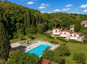 an aerial view of a house with a swimming pool and trees at Le Querciolaie with Geothermal Pool - by PosarelliVillas in Monteverdi Marittimo