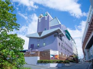 a building with a tower on the top of it at HOTEL WiLL 大高 レジャーホテル in Nagoya