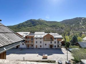 an aerial view of a building with a parking lot at L'Eterlou by Mountain Collection Immobilier in Saint-Chaffrey