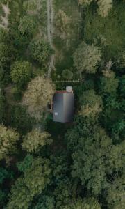 an overhead view of a forest with a building in the middle at ZenZug, a vendégház in PerÅ‘csÃ©ny
