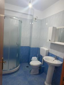a bathroom with a toilet and a shower and a sink at Shëngjin Beach Nest in Lezhë +15 photos