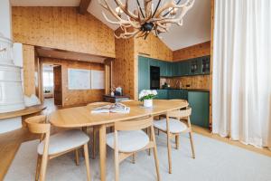 a dining room with a wooden table and chairs at Superior Hotel Schneider Ski-in & Ski-out in Obertauern