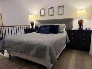 a bedroom with a bed with two night stands and two lamps at Charming and Relaxing Home in Guatemala