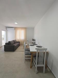 a living room with a table and a couch at DS apartments in Golem