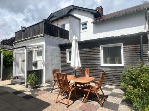 a table and chairs with an umbrella on a patio at Ferienwohnung M2 in Husby