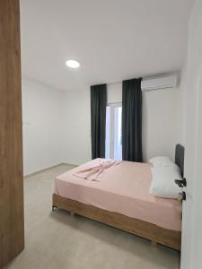a bedroom with a bed and a window at DS apartments in Golem
