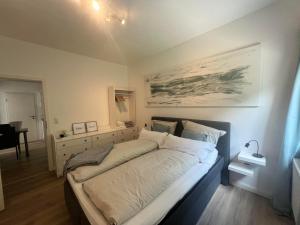 a bedroom with a large bed with a desk at Ferienwohnung M2 in Husby