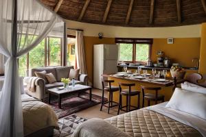 a living room with a kitchen and a dining room at Nzuri House in Nairobi