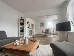 a living room with a couch and a table at Ferienwohnung M2 in Husby