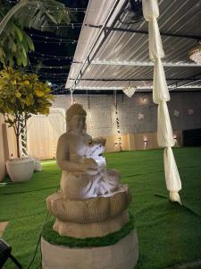 a statue of a woman holding a baby at The Courtyard Stay in Patna