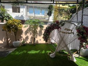 a garden with a sign that reads happy memory at The Courtyard Stay in Patna