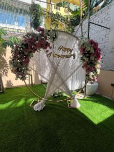 a white table with flowers and a sign that reads trumpagency at The Courtyard Stay in Patna