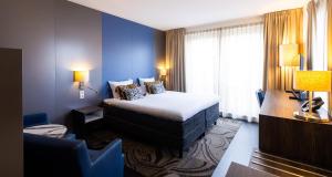 a hotel room with a bed and a window at City Hotel Gouda, WorldHotels Crafted in Gouda +64 photos