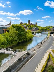 a bridge over a river next to a city at Radisson Blu Hotel, Durham in Durham +218 photos
