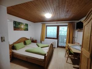 a bedroom with two beds and a table and a window at Gasthof Grünsbach in Münster +18 photos