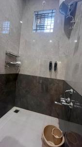 a bathroom with a toilet and a sink and a window at Lumiere Point Yercaud in Yercaud +55 photos