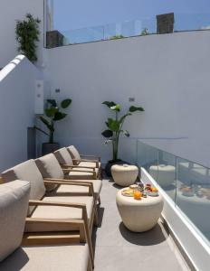 a row of chaise lounges in a room at Dagaz Suites in Fira
