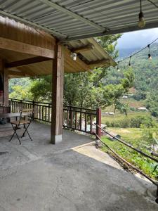 a covered porch with a view of the mountains at Chacha's House in Sapa