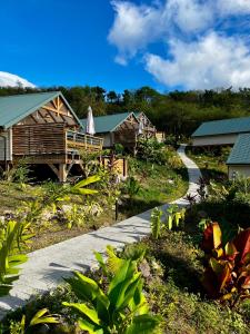 a walkway in front of a resort with houses at Caribbean Shelter in Bouillante