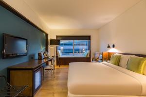 a hotel room with a large bed and a desk at Beijing New World Centre Tongpai Hotel in Beijing