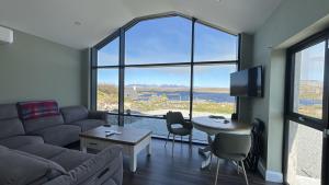 a living room with a couch and a table at Calla Retreat in Roundstone