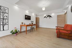 a living room with a table and a couch at CLASS ROOMS AFFITTACAMERE con bagno privato , vicino alle DUNE di PORTO PINO in SantʼAnna Arresi