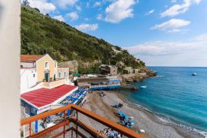 a balcony view of a beach and the ocean at Mimì sul Mare in Massa Lubrense