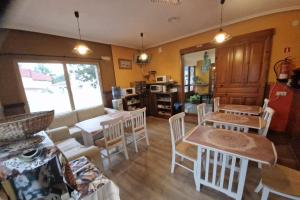 a living room with a table and chairs at Alojamientos Fermín in Cangas de Onís +59 photos