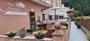 a restaurant with plants inront of a building at Alojamientos Fermín in Cangas de Onís
