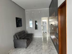 a living room with a couch and a table at Casa para temporada em SRN in São Raimundo Nonato