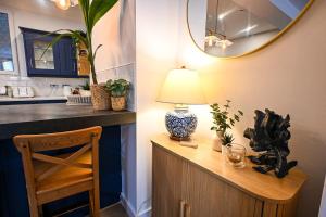 a room with a table with a lamp and a counter at Kent House in Ramsgate +37 photos