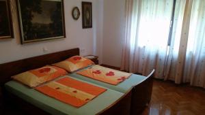 a bedroom with a bed with two pillows on it at Apartment Tatjana in Ljubljana