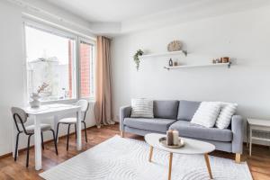 a living room with a couch and a table at Central Studio I by Elys Collection in Rovaniemi
