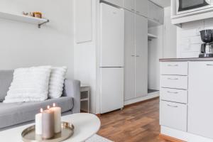 a living room with a couch and a table with candles at Central Studio I by Elys Collection in Rovaniemi +6 photos