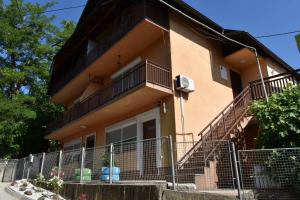 a building with a fence in front of it at Apartments Mensa in Tuzla