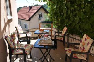 a group of chairs and a table on a patio at Apartments Mensa in Tuzla