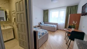 a room with a bedroom with a bed and a window at Vila Uosis in Palanga +136 photos