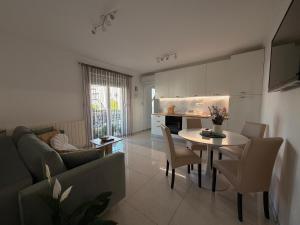 a kitchen and a living room with a table and chairs at Apartments Ostojic in Krk