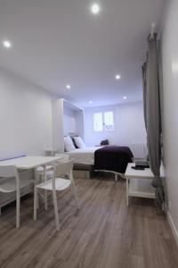 a bedroom with a bed and a desk and a table at Top Studio SV1020 Centre Vincennes 20M2 in Vincennes