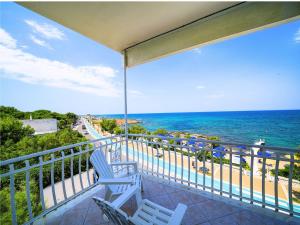 a balcony with two chairs and a view of the ocean at Hotel Club Perla in Casalabate