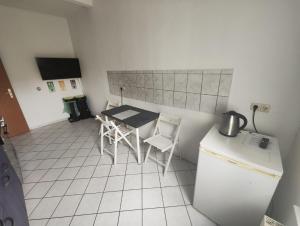 a kitchen with a table and chairs and a refrigerator at Revant West 2 in Arnstadt +1 photo