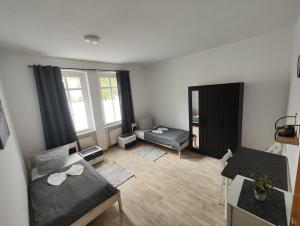a small living room with a bed and a desk at Revant West 2 in Arnstadt