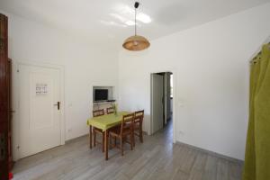 a dining room with a yellow table and chairs at Agriturismofaucci in Campo nell'Elba