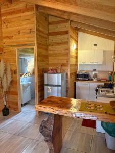 a kitchen with wooden walls and a wooden table at Parcela Peumayen Casa 4 in Pucura