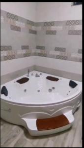 a bath tub in a room with a sink at Ko Villa in Rivière du Rempart