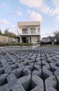 a house with a cobblestone driveway in front of it at Ko Villa in Rivière du Rempart