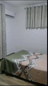 a bedroom with a bed and a window at Ko Villa in Rivière du Rempart