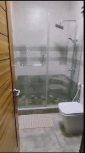 a bathroom with a shower with a toilet and a sink at Ko Villa in Rivière du Rempart