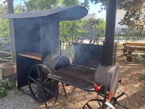 a black grill with smoke coming out of it at Къща Шепотът на бора in Varna City